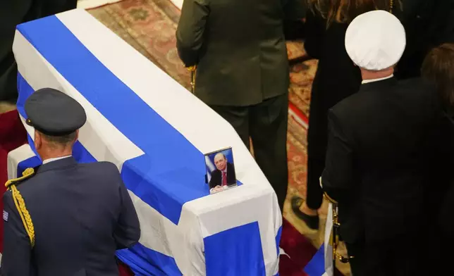 Military officers stand next to the Greek flag-draped casket during the state funeral of the late Costas Simitis former Prime Minister of Greece in Athens' central cathedral, Thursday, Jan. 9, 2025. (AP Photo/Petros Giannakouris)