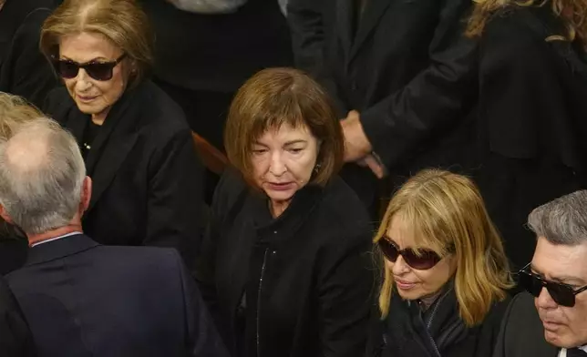 The family of the late Costas Simitis former Prime Minister, his wife Daphne Simitis, left, daughters Fiona, center, and Marilena attend the state funeral in Athens' central cathedral, Thursday, Jan. 9, 2025. (AP Photo/Petros Giannakouris)