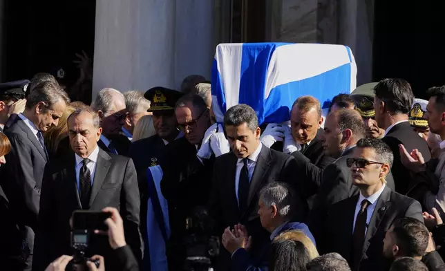 Pallbearers carry the coffin of former Greek Prime Minister Costas Simitis during his state funeral in Athens' central cathedral, Thursday, Jan. 9, 2025. (AP Photo/Petros Giannakouris)