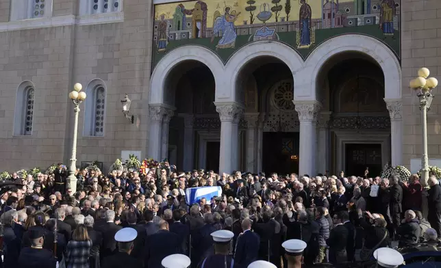 Pallbearers carry the coffin of former Greek Prime Minister Costas Simitis during his state funeral in Athens' central cathedral, Thursday, Jan. 9, 2025. (AP Photo/Petros Giannakouris)