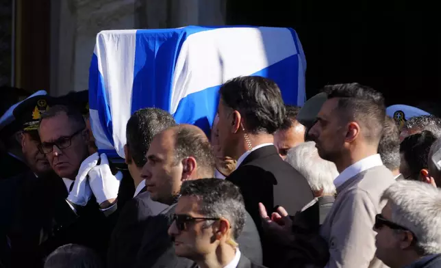 Pallbearers carry the coffin of former Greek Prime Minister Costas Simitis during his state funeral in Athens' central cathedral, Thursday, Jan. 9, 2025. (AP Photo/Petros Giannakouris)