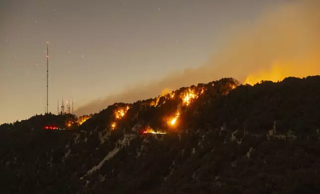 Spots of the Eaton Fire still burn after the fire swept through the mountains of the Angeles National Forest near Mount Wilson Observatory, north of Pasadena, Thursday, Jan. 9, 2025. (AP Photo/Etienne Laurent)