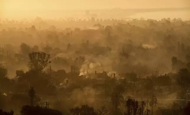 The devastation of the Palisades Fire is seen in the early morning in the Pacific Palisades neighborhood of Los Angeles, Friday, Jan. 10, 2025. (AP Photo/John Locher)