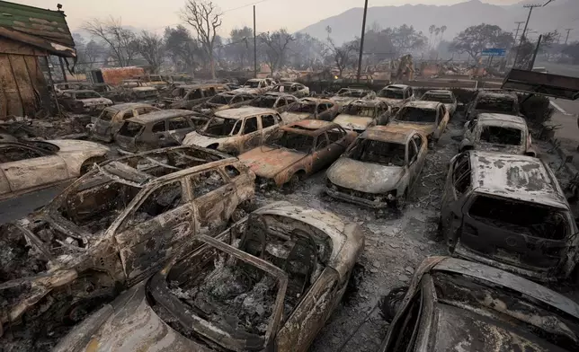 Cars are left charred inside a dealership in the aftermath of the Eaton Fire Friday, Jan. 10, 2025 in Altadena, Calif. (AP Photo/Jae C. Hong)