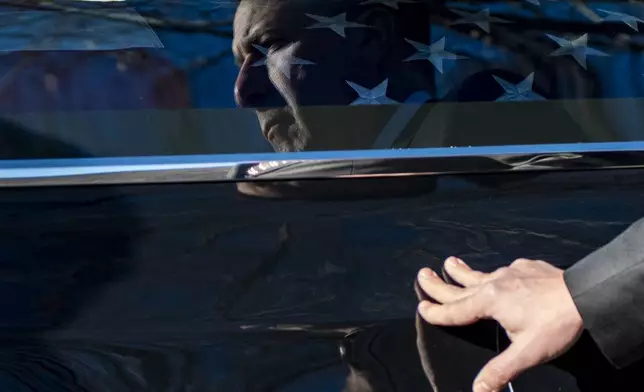 A U.S. Secret Service agent assigned to the Carter detail, places his hand on the hearse containing the casket of former President Jimmy Carter, at Phoebe Sumter Medical Center in Americus, Ga., Saturday, Jan. 4, 2025. Carter died Dec. 29 at the age of 100. (AP Photo/Alex Brandon, Pool)