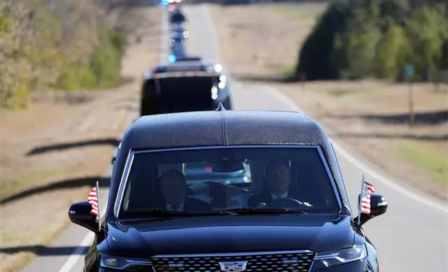 The hearse containing the casket of former President Jimmy Carter moves toward Plains, Ga., Saturday, Jan. 4, 2025. Carter died Dec. 29 at the age of 100. (AP Photo/Alex Brandon, Pool)