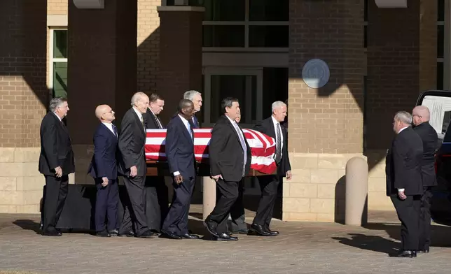 Former and current U.S. Secret Service agents assigned to the Carter detail, move the flag-draped casket of former President Jimmy Carter, at Phoebe Sumter Medical Center in Americus, Ga., Saturday, Jan. 4, 2025. Carter died Dec. 29 at the age of 100. (AP Photo/Alex Brandon, Pool)