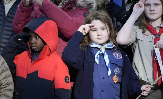 Children watch as the hearse carrying the flag-draped casket of former President Jimmy Carter pauses outside the State Capitol in Atlanta, Saturday, Jan. 4, 2025. Carter died Dec. 29 at the age of 100. (AP Photo/Alex Brandon, Pool)