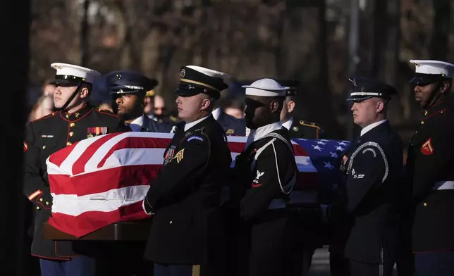 A military body bearer team carries the casket of former President Jimmy Carter into the Jimmy Carter Presidential Library and Museum to lie in repose in Atlanta, Saturday, Jan. 4, 2025. Carter died Dec. 29 at the age of 100. (AP Photo/Brynn Anderson, Pool)