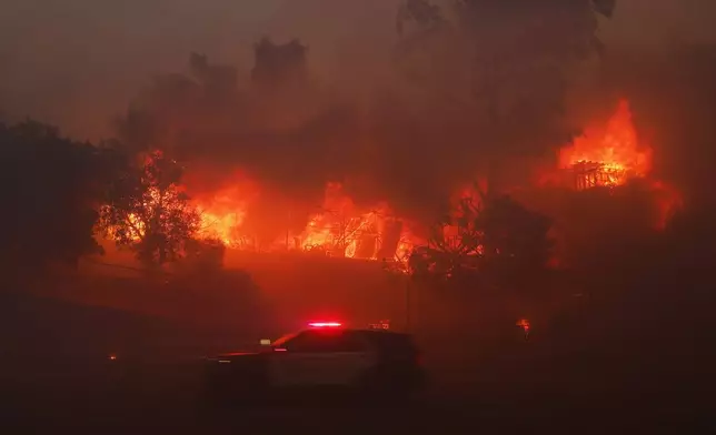 The Palisades Fire burns a property in the Pacific Palisades neighborhood of Los Angeles, Tuesday, Jan. 7, 2025. (AP Photo/Etienne Laurent)