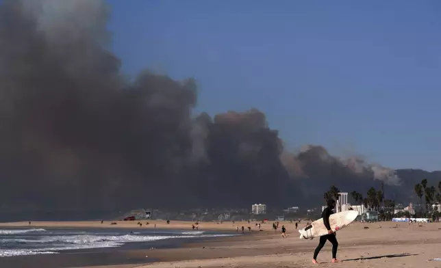 Smoke from a wildfire is seen from the Venice Beach section of Los Angeles, Tuesday, Jan. 7, 2025. (AP Photo/Jae C. Hong)