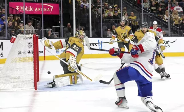 Montreal Canadiens right wing Cole Caufield, front right, scores against Vegas Golden Knights goaltender Adin Hill (33) during the second period of an NHL hockey game Tuesday, Dec. 31, 2024, in Las Vegas. (Steve Marcus/Las Vegas Sun via AP)