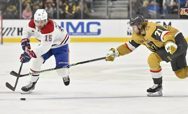 Montreal Canadiens center Alex Newhook (15) and Vegas Golden Knights center William Karlsson (71) vie for the puck during the first period of an NHL hockey game Tuesday, Dec. 31, 2024, in Las Vegas. (AP Photo/David Becker)