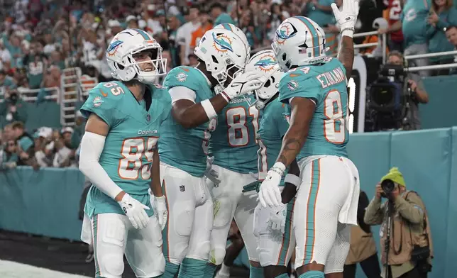 Miami Dolphins wide receiver Tyreek Hill (10) celebrates his touchdown with his teammates during the first half of an NFL football game against the San Francisco 49ers, Sunday, Dec. 22, 2024, in Miami Gardens, Fla. (AP Photo/Rebecca Blackwell)