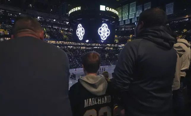 Members of the Skating Club of Boston community, athletes, coaches and family who were killed when an American Airlines flight collided with an Army helicopter Wednesday, Jan. 29, 2025, and crashed into the Potomac River in Washington, are honored prior to an NHL hockey game between the Boston Bruins and Winnipeg Jets, Thursday, Jan. 30, in Boston. (AP Photo/Charles Krupa)
