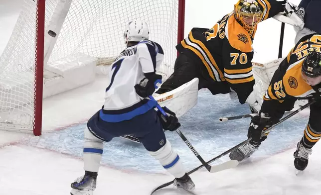 Winnipeg Jets center Vladislav Namestnikov (7) backhands a shot for a goal against Boston Bruins goaltender Joonas Korpisalo (70) during the first period of an NHL hockey game, Thursday, Jan. 30, 2025, in Boston. (AP Photo/Charles Krupa)