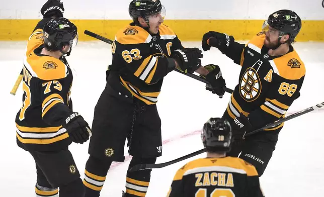 Boston Bruins left wing Brad Marchand (63) is congratulated after his goal against the Winnipeg Jets during the first period of an NHL hockey game, Thursday, Jan. 30, 2025, in Boston. (AP Photo/Charles Krupa)