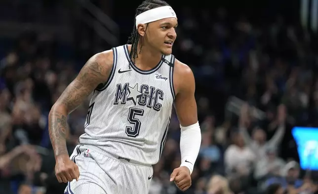 Orlando Magic forward Paolo Banchero (5) reacts after making shot against the Milwaukee Bucks during the first half of an NBA basketball game, Friday, Jan. 10, 2025, in Orlando, Fla. (AP Photo/John Raoux)