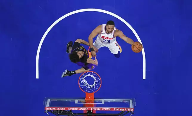 Philadelphia 76ers' Eric Gordon, right, goes up for a shot against Los Angeles Lakers' Jaxson Hayes during the first half of an NBA basketball game, Tuesday, Jan. 28, 2025, in Philadelphia. (AP Photo/Matt Slocum)