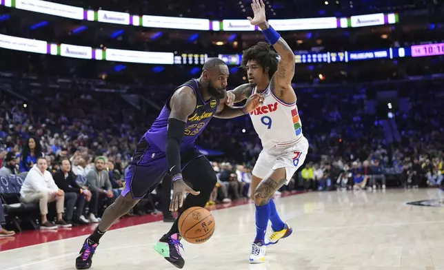 Los Angeles Lakers' LeBron James, left, tries to get past Philadelphia 76ers' Kelly Oubre Jr. during the first half of an NBA basketball game, Tuesday, Jan. 28, 2025, in Philadelphia. (AP Photo/Matt Slocum)