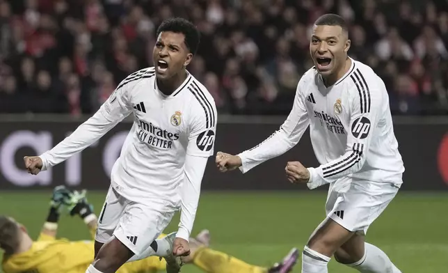 Real Madrid's Rodrygo, left, celebrates with his teammate Kylian Mbappe after scoring his side's third goal during the Champions League opening phase soccer match between Brest and Real Madrid at Roudourou stadium in Guingamp, France, Wednesday, Jan. 29, 2025. (AP Photo/Thibault Camus)