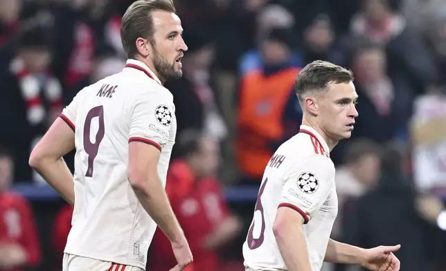 Munich's Harry Kane, left, celebrates after scoring his side's second goal with Joshua Kimmich during the Champions League opening phase soccer match between Bayern Munich and Slovan Bratislava at the Allianz Arena in Munich, Germany, Jan. 29, 2025. (Sven Hoppe/dpa via AP)