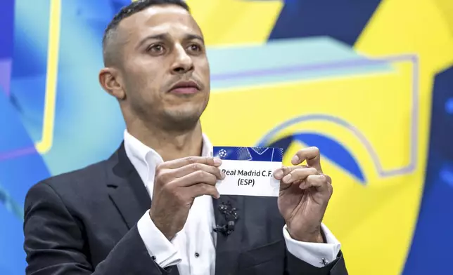 Spain's former player Thiago Alcantara shows a ticket of Real Madrid during the UEFA Champions League knockout phase play-off draw, at the UEFA headquarters in Nyon, Switzerland, Friday, Jan. 31, 2025. (Martial Trezzini/Keystone via AP)