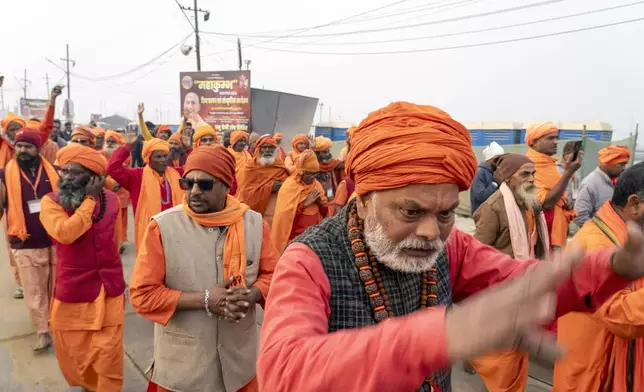 Hindu holy men walk in a procession a day before the 45-day-long Maha Kumbh festival, at the confluence of the Ganges, the Yamuna and the mythical Saraswati rivers, in Prayagraj, India, Sunday, Jan. 12, 2025. (AP Photo/Ashwini Bhatia)