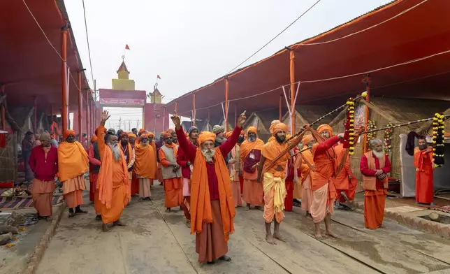 Hindu holy men arrive in a procession at an akhara where they will stay during the 45-day-long Maha Kumbh festival beginning on Jan. 13, at the confluence of the Ganges, the Yamuna and the mythical Saraswati rivers, in Prayagraj, India, Sunday, Jan. 12, 2025. (AP Photo/Ashwini Bhatia)
