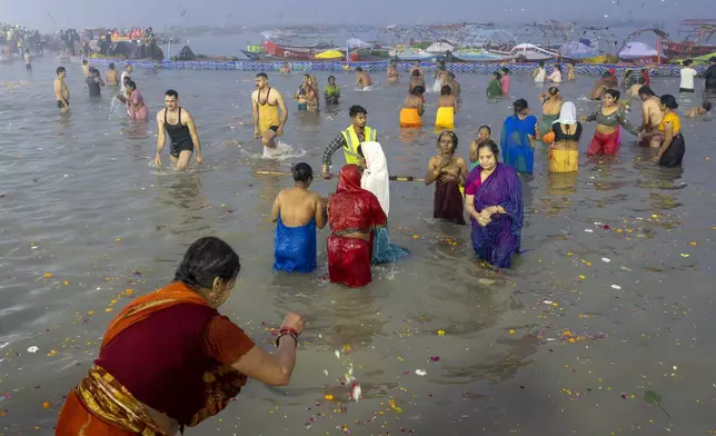 Hindu devotees bathe at the confluence of the Ganges, the Yamuna and the mythical Saraswati rivers on the first day of the 45-day-long Maha Kumbh festival in Prayagraj, India, Monday, Jan. 13, 2025. (AP Photo/Ashwini Bhatia)