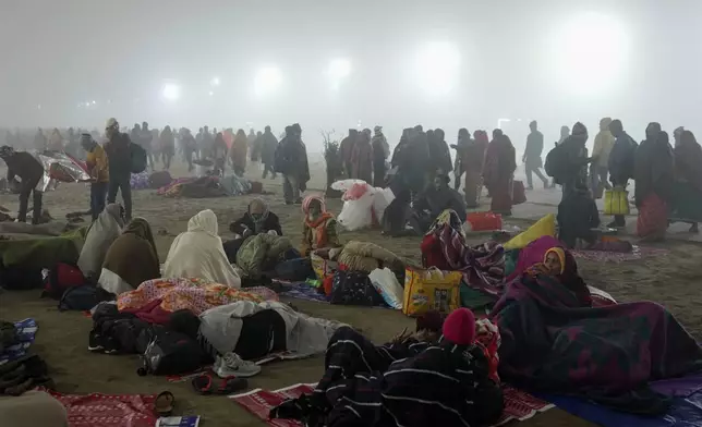 Devotees arrive for taking a dip at the confluence of the Ganges, the Yamuna and the mythical Saraswati rivers on the first day of the 45-day-long Maha Kumbh festival in Prayagraj, India, Monday, Jan. 13, 2025. (AP Photo/Rajesh Kumar Singh)