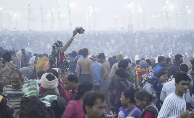 Hindu devotees gather to take a holy dip in the banks of the Sangam, the confluence of the Ganges, the Yamuna and the mythical Saraswati rivers, on "Mauni Amavasya" or new moon day during the Maha Kumbh festival in Prayagraj, Uttar Pradesh, India, Wednesday, Jan. 29, 2025. (AP Photo/Deepak Sharma)