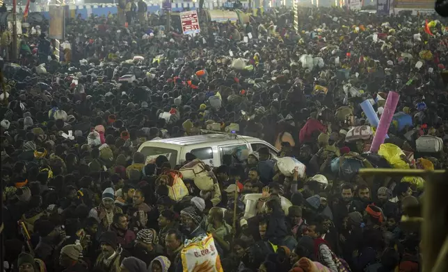 An ambulance moves in the middle of a crowd of Hindu devotees gathered for a holy dip by the banks of the Sangam, the confluence of the Ganges, the Yamuna and the mythical Saraswati rivers, on Mauni Amavasya' or new moon day during the Maha Kumbh festival in Prayagraj, Uttar Pradesh, India, Wednesay, Jan. 29, 2025. (AP Photo/Deepak Sharma)