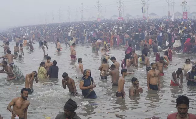 Hindu devotees take a holy dip by the banks of the Sangam, the confluence of the Ganges, the Yamuna and the mythical Saraswati rivers, on "Mauni Amavasya" or new moon day during the Maha Kumbh festival in Prayagraj, Uttar Pradesh, India, Wednesday, Jan. 29, 2025. (AP Photo/Deepak Sharma)