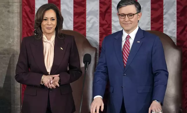 Vice President Kamala Harris stands with House Speaker Mike Johnson of La., as a joint session of Congress convenes to confirm the Electoral College votes, affirming President-elect Donald Trump's victory in the presidential election, Monday, Jan. 6, 2025, at the U.S. Capitol in Washington. (AP Photo/Matt Rourke)