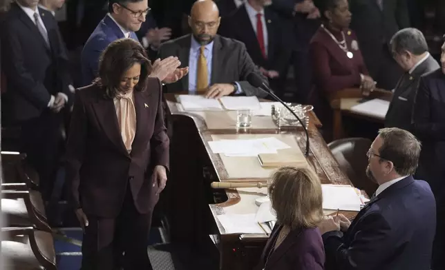 Vice President Kamala Harris walks off the dais in the House Chamber after she announced President-elect Donald Trump had won the presidential election, Monday, Jan. 6, 2025, at the U.S. Capitol in Washington, as Speaker of the House Mike Johnson applauds and looks on. (AP Photo/J. Scott Applewhite)