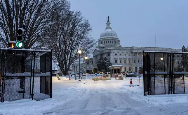 Security fencing surrounds Capitol Hill as snow blankets the region ahead of a joint session of Congress to certify the votes from the Electoral College in the presidential election, in Washington, Monday, Jan. 6, 2025. (AP Photo/J. Scott Applewhite)