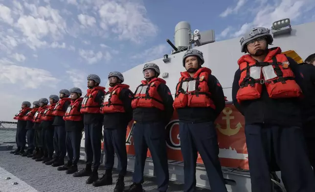 Deck crew of Taiwanese navy stand by on a Taiwan's domestically made Tuo Chiang patrol ship during a simulated attack drill off Kaohsiung City, southern Taiwan, Thursday, Jan. 9, 2025. (AP Photo/Chiang Ying-ying)