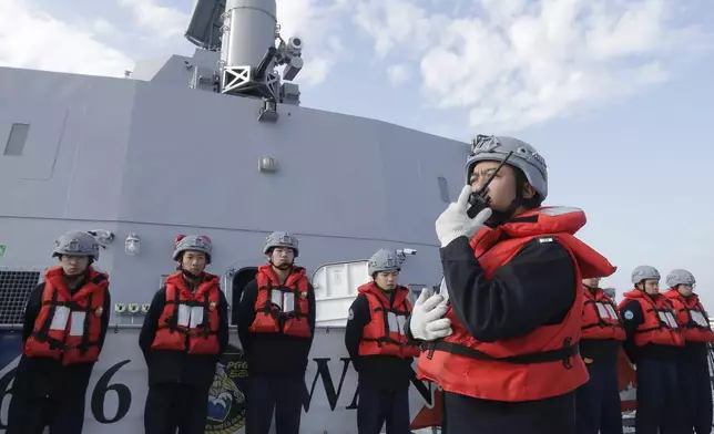 Deck crew of Taiwanese navy stand by on a Taiwan's domestically made Tuo Chiang patrol ship during a simulated attack drill off Kaohsiung City, southern Taiwan, Thursday, Jan. 9, 2025. (AP Photo/Chiang Ying-ying)