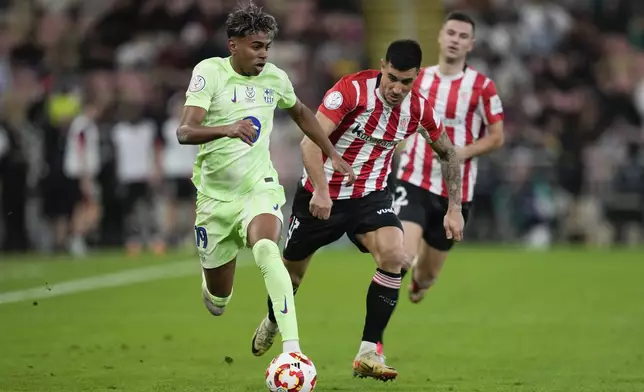 Barcelona's Lamine Yamal in action in front of Athletic Bilbao's Yuri Berchiche during the Spanish Super Cup semifinal match between Athletic Bilbao and Barcelona in Jeddah, Saudi Arabia, on Wednesday, Jan. 8, 2025. (AP Photo/Altaf Qadri)