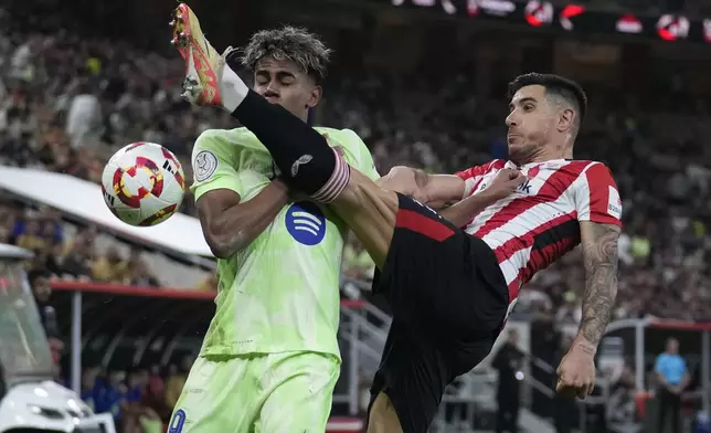 Barcelona's Lamine Yamal, left, and Athletic Bilbao's Yuri Berchiche fight for the ball during the Spanish Super Cup semifinal match between Athletic Bilbao and Barcelona in Jeddah, Saudi Arabia, on Wednesday, Jan. 8, 2025. (AP Photo/Altaf Qadri)