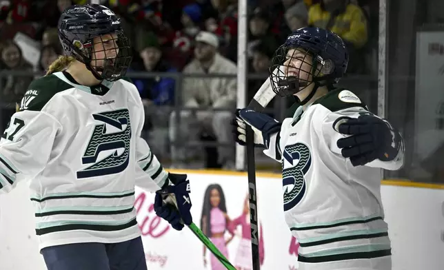 Boston Fleet's Sidney Morin, right, celebrates after her winning goal against the Ottawa Charge with teammate Shay Maloney (27) in overtime PWHL hockey game action in Ottawa, Ontario, Saturday, Jan. 11, 2025. (Justin Tang/The Canadian Press via AP)