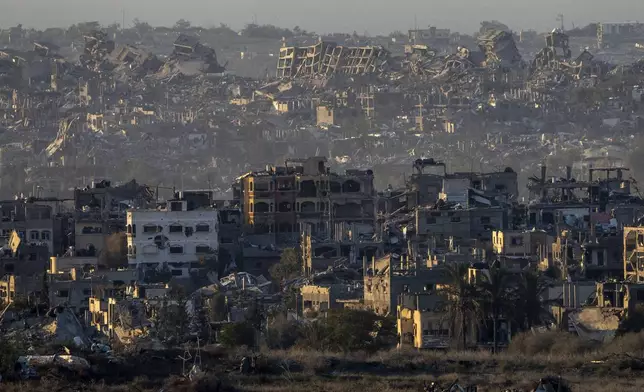 Destroyed buildings stand inside the Gaza Strip, as seen from southern Israel, Tuesday, Jan. 7, 2025. (AP Photo/Ariel Schalit)