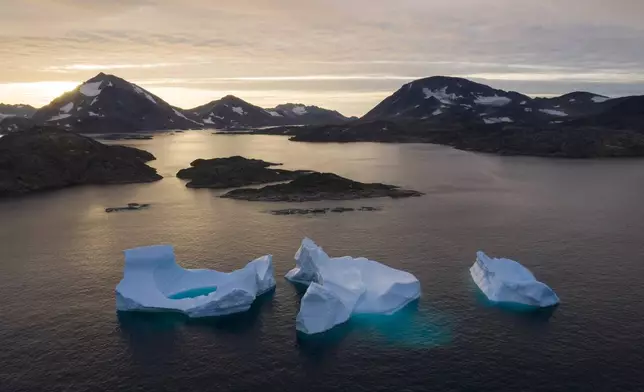 FILE - Large icebergs float away as the sun rises near Kulusuk, Greenland, on Aug. 16, 2019. (AP Photo/Felipe Dana, File)