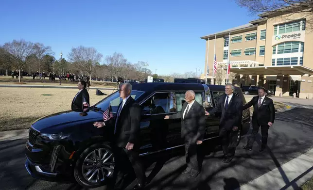 Former and current U.S. Secret Service agents assigned to the Carter detail, walk with the hearse carrying flag-draped casket of former President Jimmy Carter, at Phoebe Sumter Medical Center in Americus, Ga., Saturday, Jan. 4, 2025. Carter died Dec. 29 at the age of 100. (AP Photo/Alex Brandon, Pool)