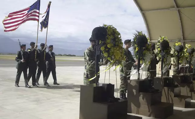 FILE - U.S. soldiers carry an American flag in a memorial service for five U.S. soldiers at the Soto Cano Airbase in Palmerola, north of Tegucigalpa, Dec. 14, 2002. The soldiers, who belonged to the 1st Battalion-228th Aviation Regiment, part of the U.S. Army South in Puerto Rico, were killed when their UH-60 Black Hawk helicopter crashed after a night training exercise. (AP Photo/Ginnette Riquelme, File)