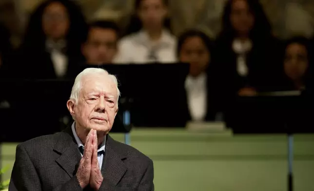 FILE - Former President Jimmy Carter teaches Sunday school class at Maranatha Baptist Church in his hometown, Aug. 23, 2015, in Plains, Ga. The 90-year-old Carter gave one lesson to about 300 people filling the small Baptist church that he and his wife, Rosalynn, attend. It was Carter's first lesson since detailing the intravenous drug doses and radiation treatment planned to treat melanoma found in his brain after surgery to remove a tumor from his liver. (AP Photo/David Goldman, File)