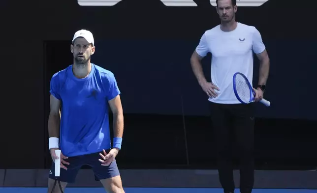 Serbia's Novak Djokovic is watches his coach Andy Murray, right, during a practice session ahead of the Australian Open tennis championship in Melbourne, Australia, Thursday, Jan. 9, 2025. (AP Photo/Mark Baker)