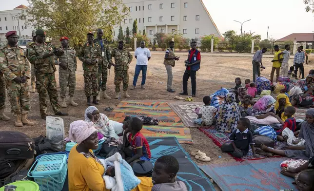 South Sudan People's Defense Forces (SSPDF)'s senior officials, visit Sudanese nationals seeking safety at the army headquarters after a night of violence in Juba, South Sudan, on Friday, Jan. 17, 2025. (AP Photo/Florence Miettaux)