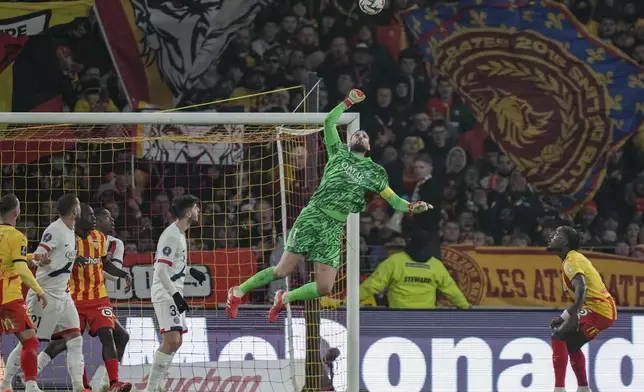 PSG's goalkeeper Gianluigi Donnarumma, center, saves the goal during the French League One soccer match between Lens and Paris Saint-Germain, at the Bollaert-Delelis stadium in Lens, France, Saturday, Jan. 18, 2025. (AP Photo/Thibault Camus)